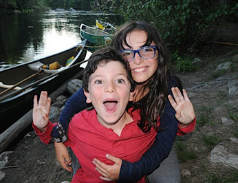 Two kids having fun after a long canoe trip